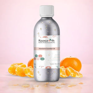 Bottle of Raasa Oils Mandarin Essential Oil with mandarin slices on a pink background