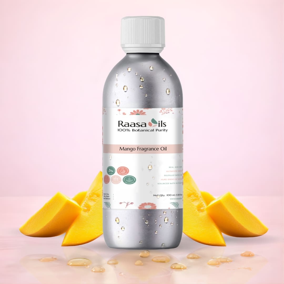 Bottle of Raasa Oils Mango Fragrance Oil with mango slices on a pink background