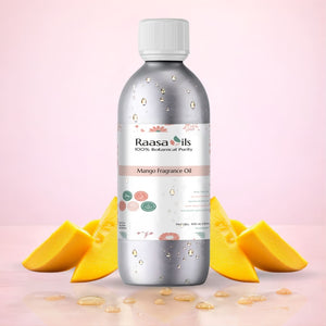Bottle of Raasa Oils Mango Fragrance Oil with mango slices on a pink background