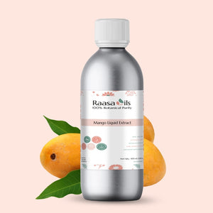 Bottle of Raasa Oils Mango Liquid Extract with mangoes and a leaf on a light pink background