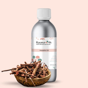 Raasa Oils Manjitha Oil bottle with a bowl of cinnamon sticks on a beige background