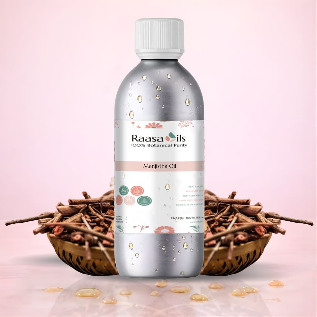 Bottle of Raasa Oils Manjitha Oil with dry herbs on a pink background