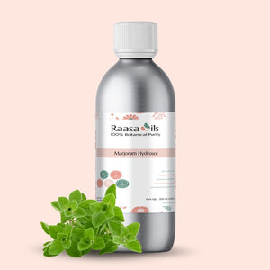 Bottle of Raasa Oils Marjoram Hydrosol with marjoram leaves on a beige background