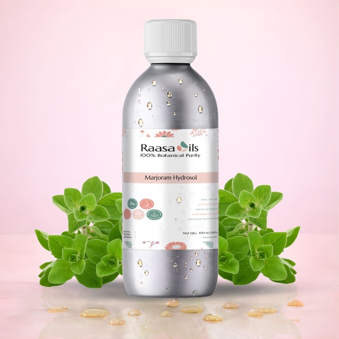 Raasa Oils bottle with marjoram leaves on a pink background
