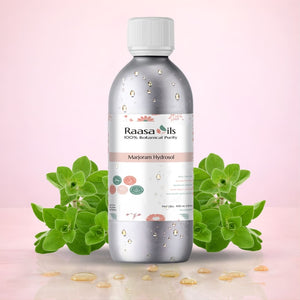 Raasa Oils bottle with marjoram leaves on a pink background