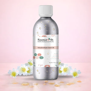 Bottle of Raasa Oils Meadowfoam Seed Oil with flowers on a light pink background