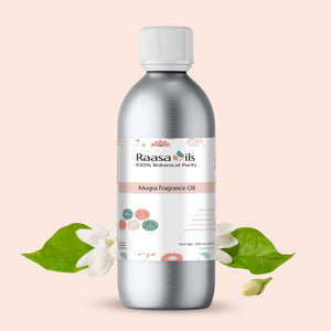 Raasa Oils MoGRA Fragrance Oil bottle with leaves on a light pink background
