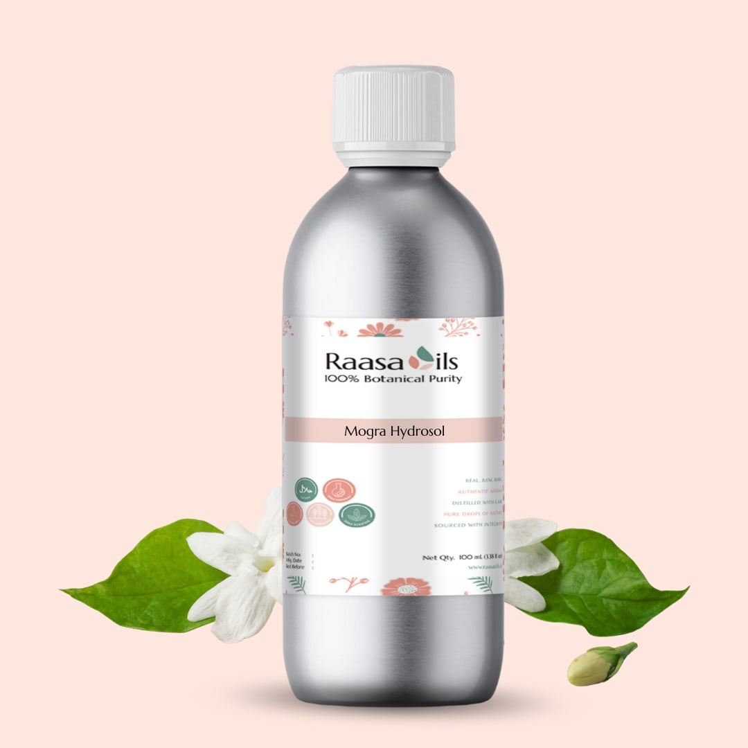 Bottle of Raasa Oils Mogra Hydrosol with floral and leaf elements on a light pink background