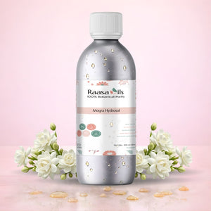 Raasa Oils Mogra Fragrance Oil bottle with flowers on a pink background
