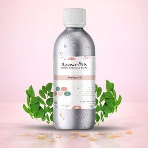 Bottle of Raasa Oils Moringa Oil with green leaves on a pink background