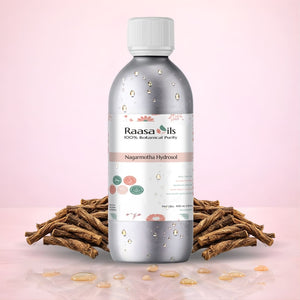 Raasa Oils bottle with roots on a pink background