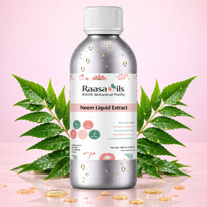 A bottle of Raasails Neem Liquid Extract centered on a pink background, flanked by green neem leaves and scattered golden oil droplets. The bottle is metallic silver with a white cap and a white label featuring pink floral accents and product text.