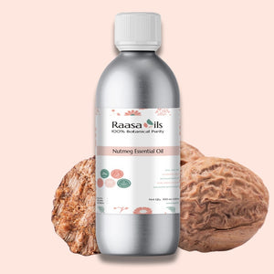 Bottle of Raasa Oils Nutmeg Essential Oil with two nuts on a light pink background