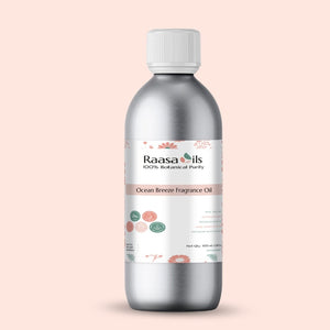 Bottle of Raasa Oils Ocean Breeze Fragrance Oil on a light pink background