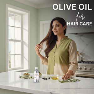 Woman with long hair standing in a kitchen with olive oil products on the counter.