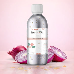 Bottle of Raasa Oils Onion Essential Oil with onions on a pink background