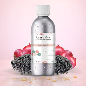Bottle of Raasa Oils Onion Seed Oil with onions and seeds on a pink background