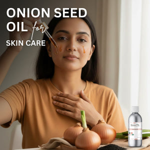 Woman applying onion seed oil to her face with a dropper, surrounded by onions and a bottle of oil.