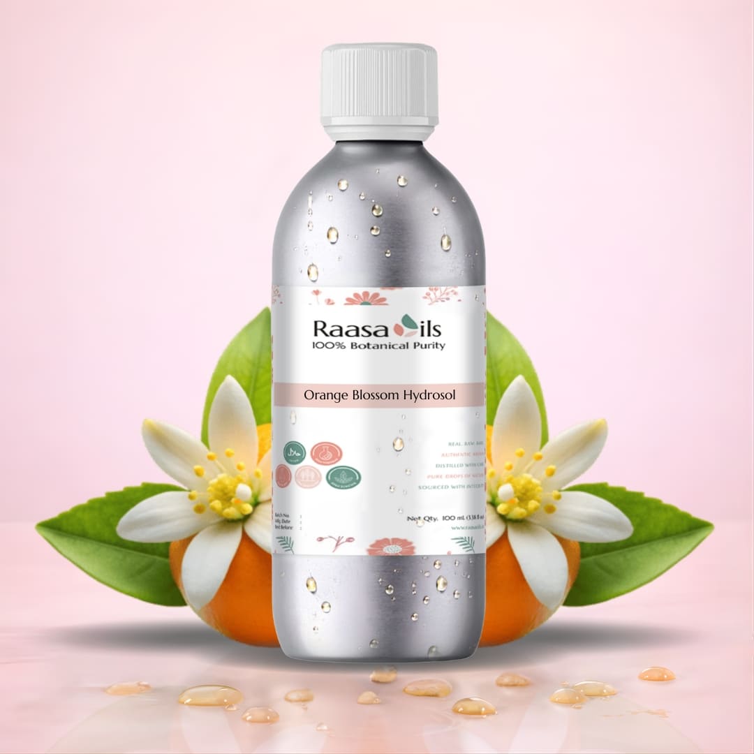 Bottle of Raasa Oils Orange Blossom Hydrosol with orange flowers on a light pink background