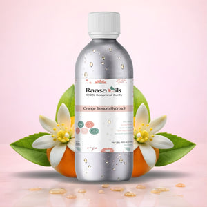 Bottle of Raasa Oils Orange Blossom Hydrosol with orange flowers on a light pink background