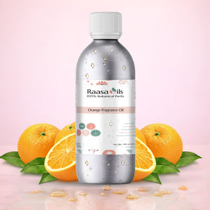 Bottle of Raasa Oils Orange Fragrance Oil with oranges and leaves on a pink background