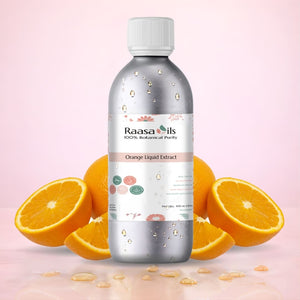 Bottle of Raasa Oils Orange Liquid Extract with oranges on a pink background