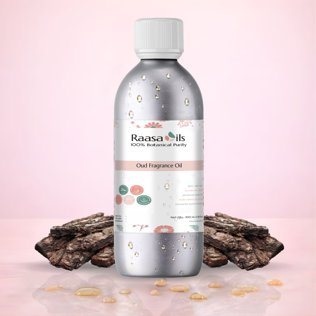 Bottle of Raasa Oils Oud Fragrance Oil with dried oud wood on a pink background