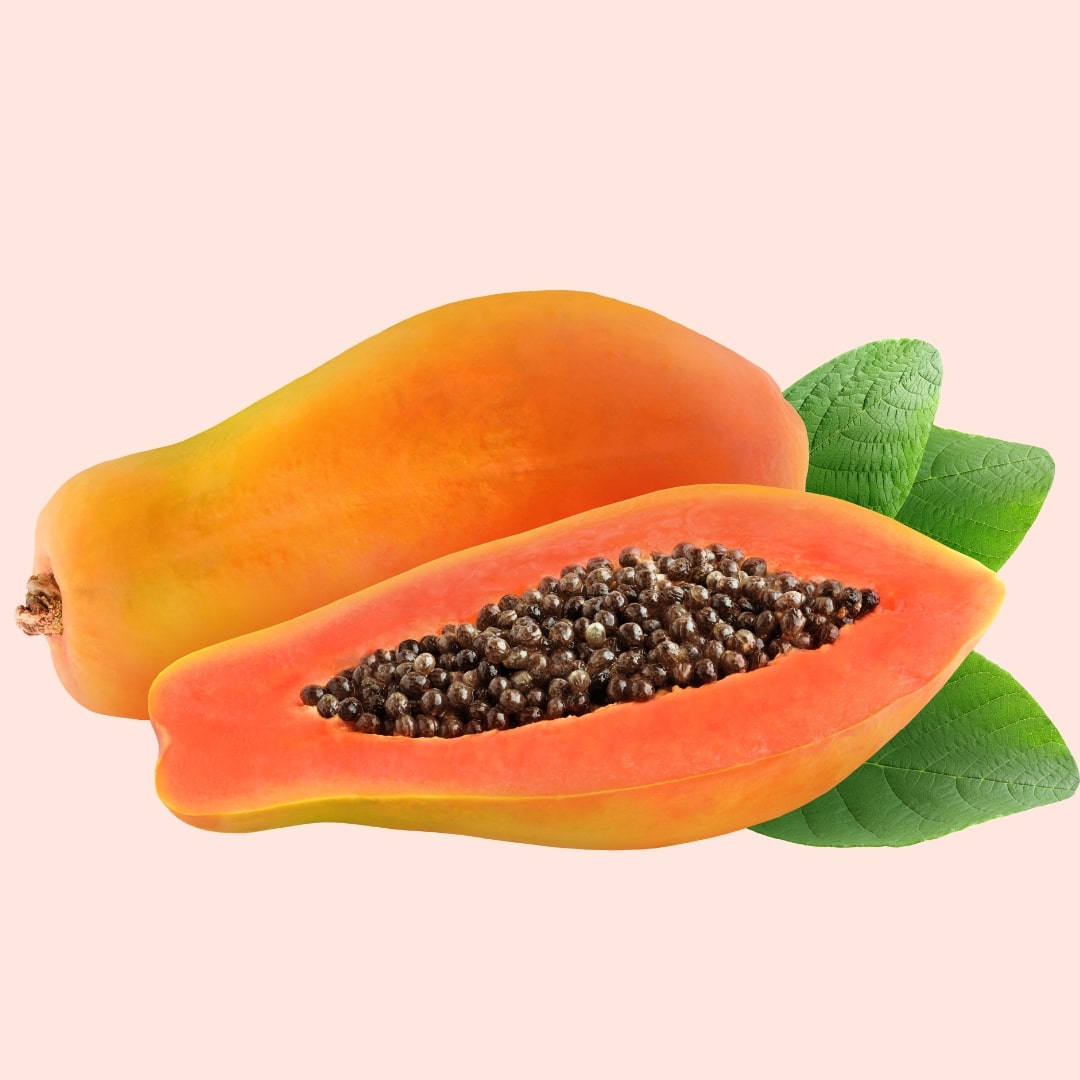 Papaya with a cross-section revealing seeds on a beige background