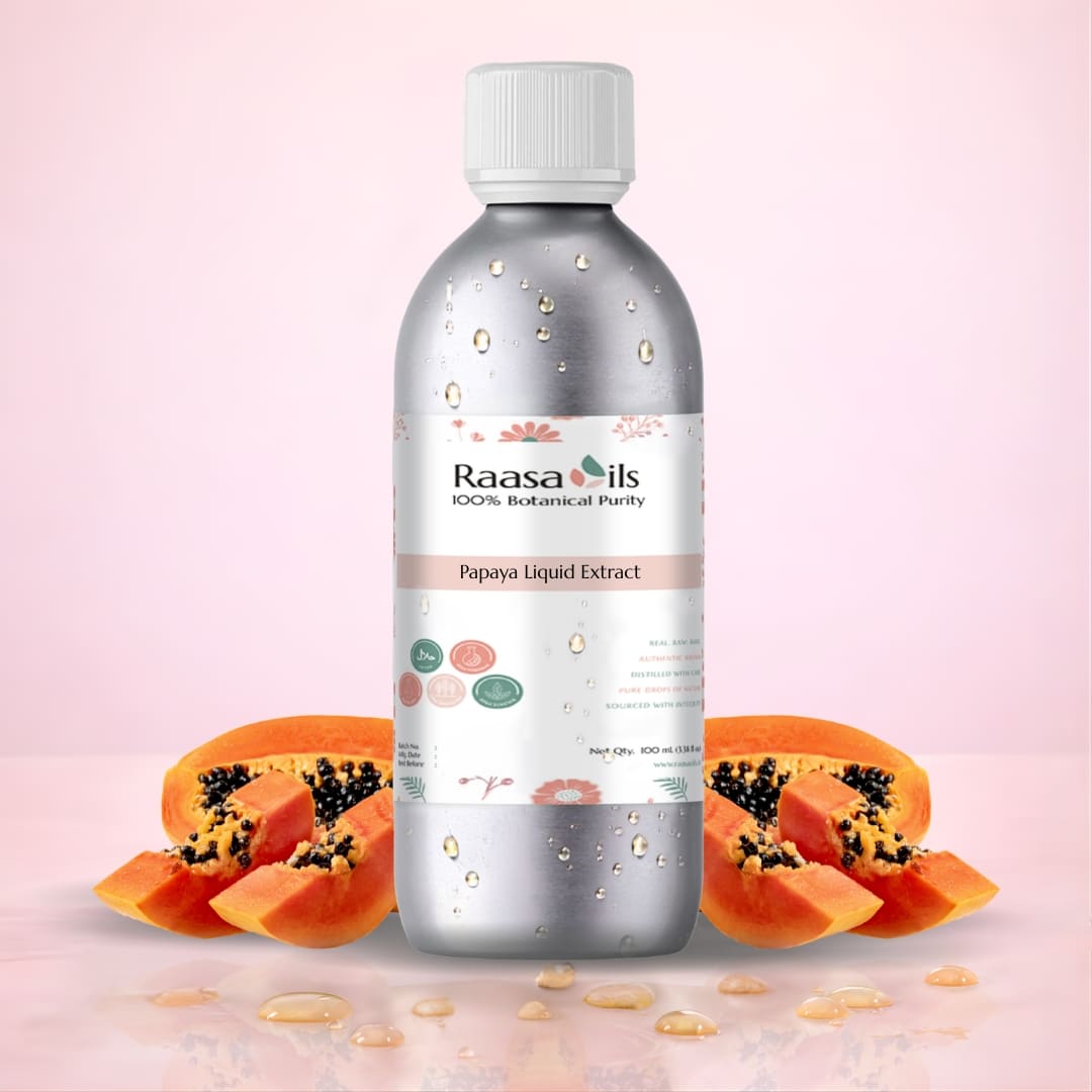 Bottle of Raasa Oils Papaya Liquid Extract with papaya slices on a pink background