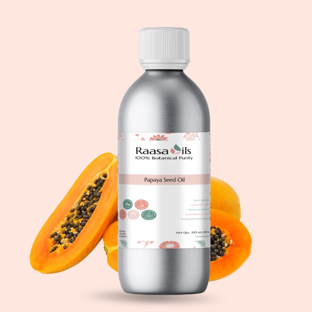 Bottle of Raasa Oils Papaya Seed Oil with two papayas on a beige background