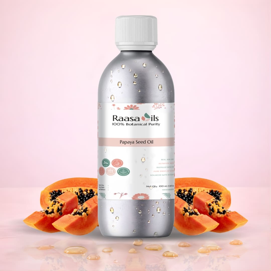 Bottle of Raasa Oils Papaya Seed Oil with papaya slices on a pink background