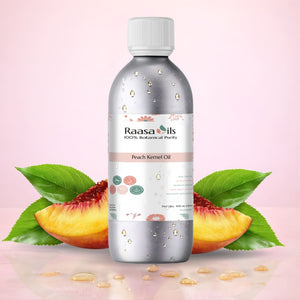 Bottle of Raasa Oils Peach Kernel Oil with peach slices and leaves on a pink background