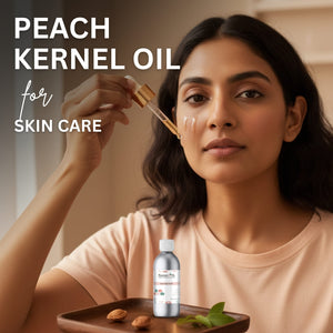 Woman applying peach kernel oil to her face with a dropper, next to a bottle of the product.