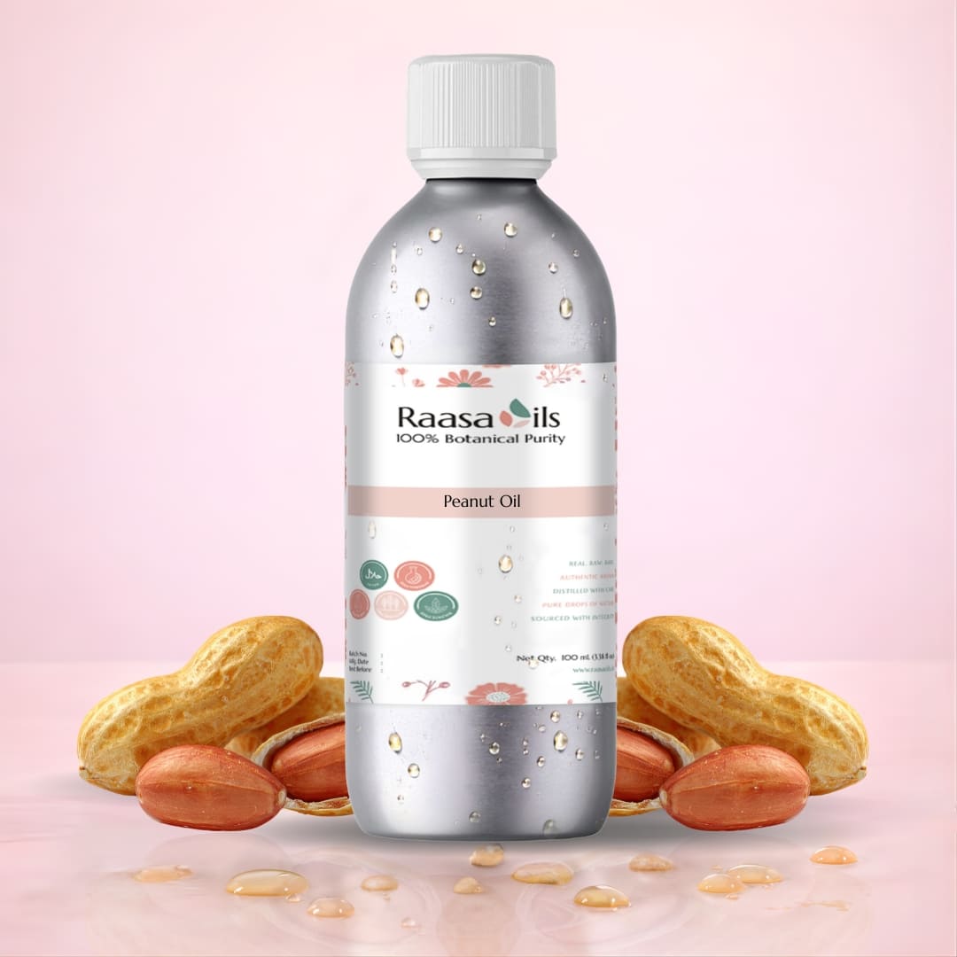 Bottle of Raasa Oils peanut oil with peanuts on a pink background