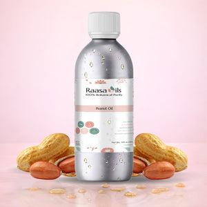Bottle of Raasa Oils peanut oil with peanuts on a pink background