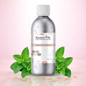 Raasa Oils peppermint essential oil bottle with mint leaves on a pink background