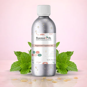 Bottle of Raasa Oils Peppermint Fragrance Oil with peppermint leaves on a pink background