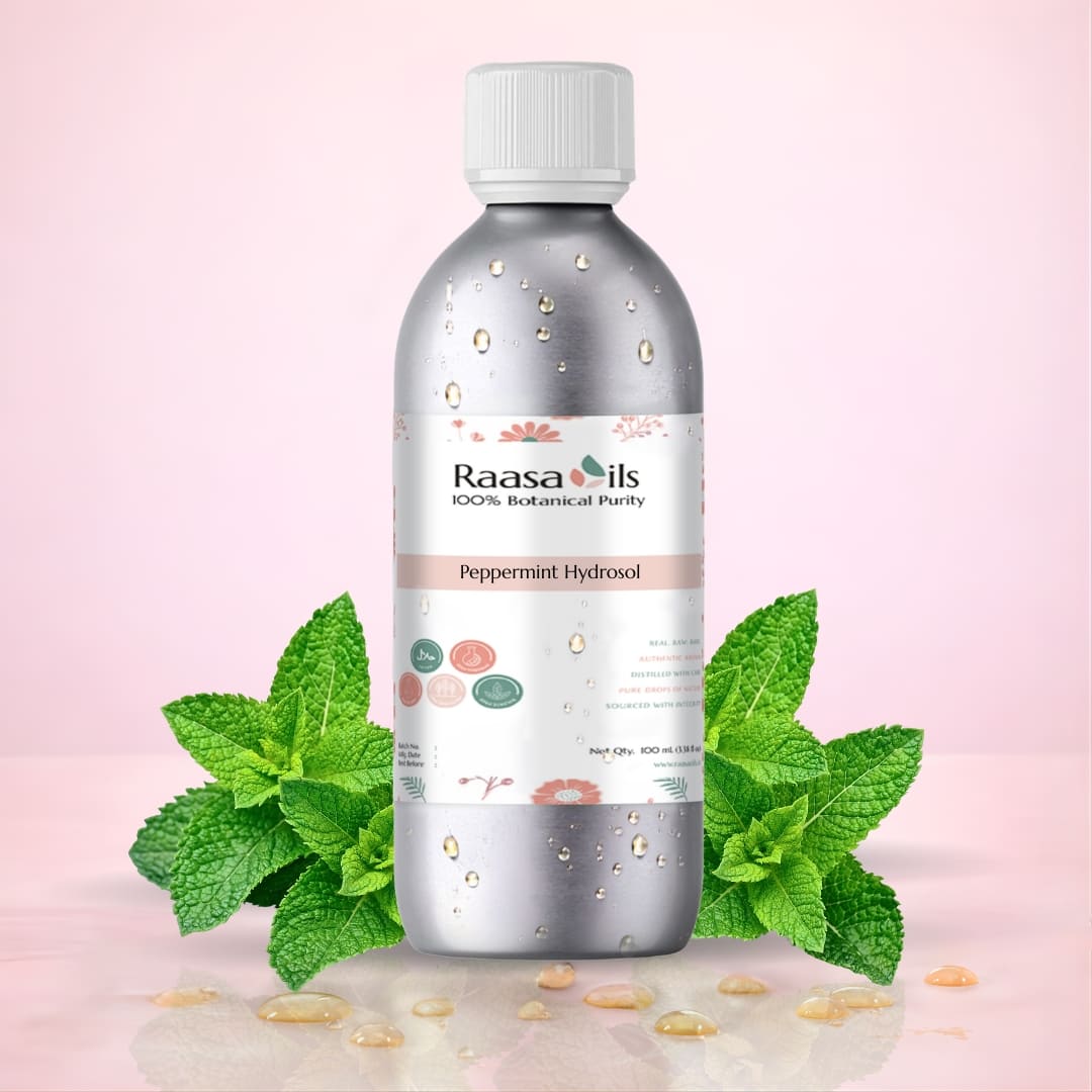 Raasa Oils peppermint hydrosol bottle with mint leaves on a pink background