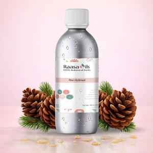 Bottle of Raasa Oils Pine Hydrosol with pine cones and leaves on a pink background