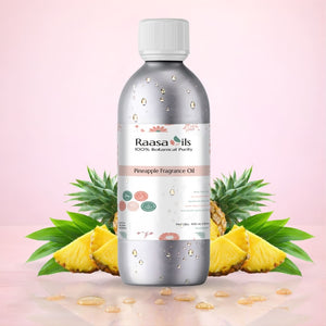 Bottle of Raasa Oils pineapple fragrance oil with a pineapple and leaves on a light pink background