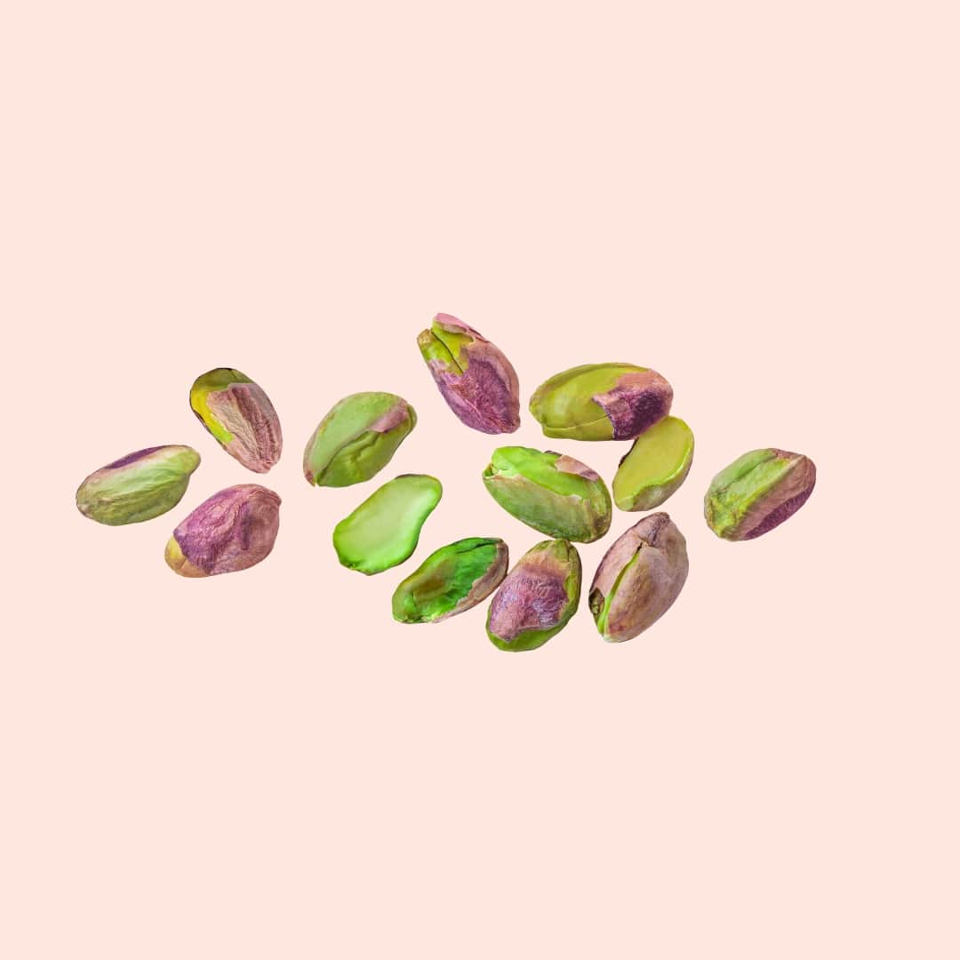 Pistachio shells on a pink background