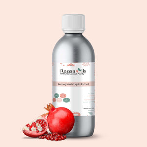 Bottle of Raasa Oils Pomegranate Liquid Extract with pomegranate fruit on a beige background