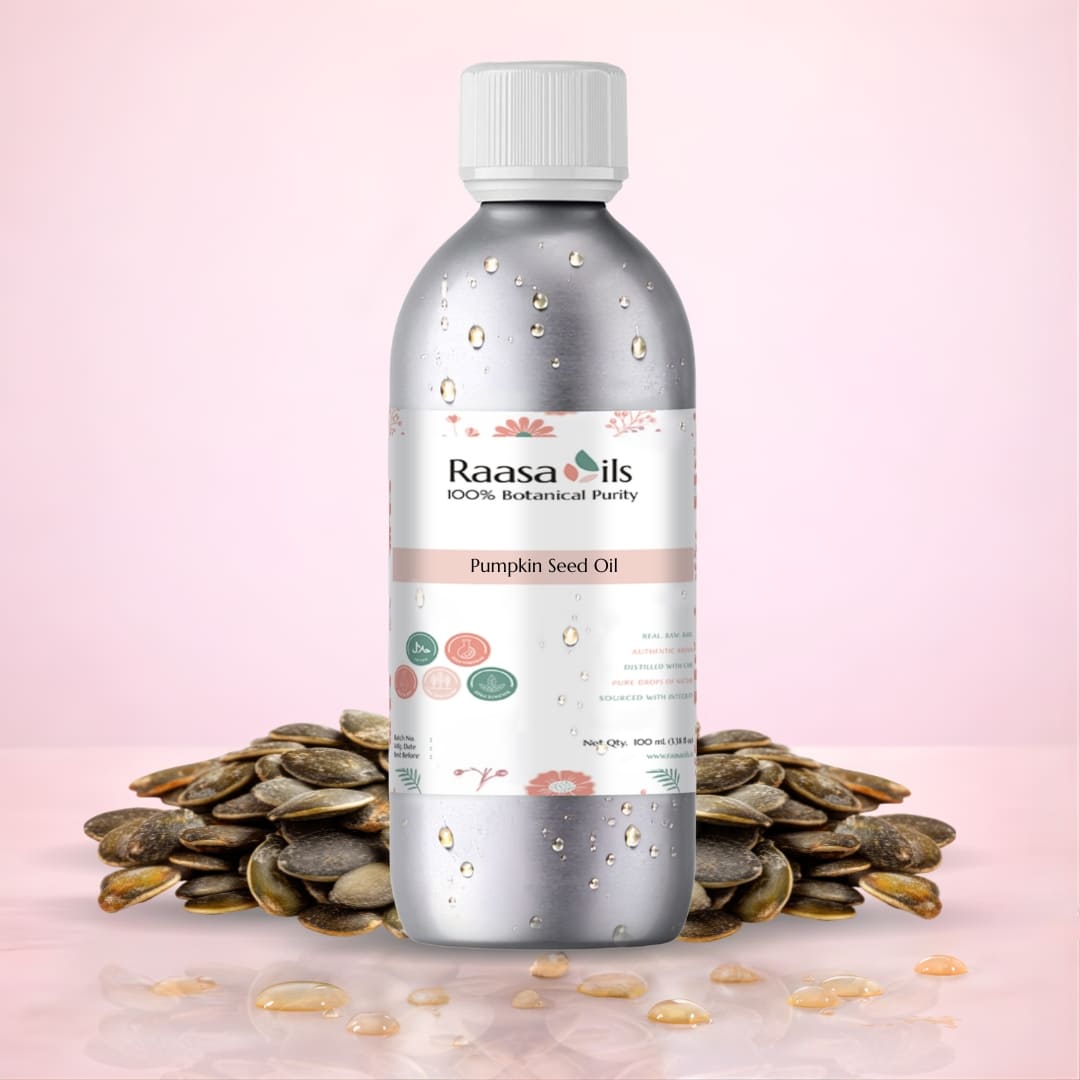 Bottle of Raasa Oils pumpkin seed oil with seeds on a pink background