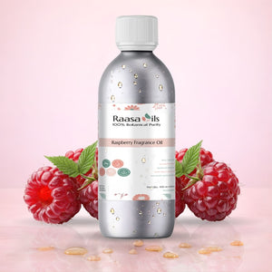 Bottle of Raasa Oils Raspberry Fragrance Oil with raspberries on a pink background