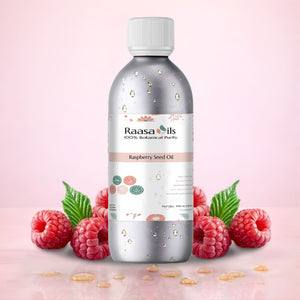 Bottle of Raasa Oils Raspberry Seed Oil with raspberries on a pink background