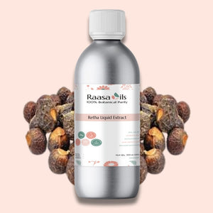 Bottle of Raasa Oils Retha Liquid Extract with dried Retha fruits on a light pink background