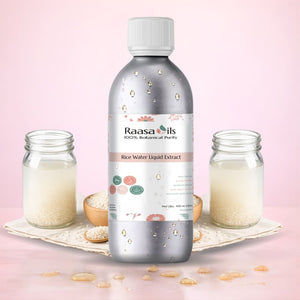 Bottle of Raasa Oils Rice Water Liquid Extract with jars and rice on a pink background
