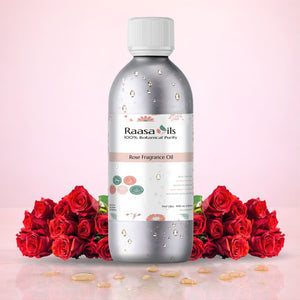Raasa Oils Rose Fragrance Oil bottle with red roses on a pink background