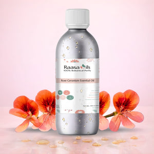 Bottle of Raasa Oils Rose Geranium Essential Oil with pink flowers on a light pink background