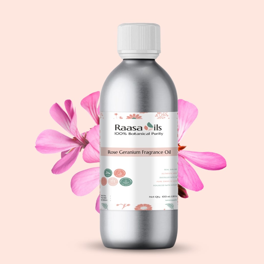 Bottle of Raasa Oils Rose Geranium Fragrance Oil with pink flowers on a light pink background